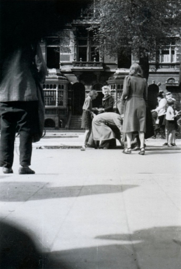 Hans Sibbelee (Dutch, 1915-2003) 'Children on Sarphatistraat remove the impregnated wooden blocks from between the tram rails, for the stove' March 1945