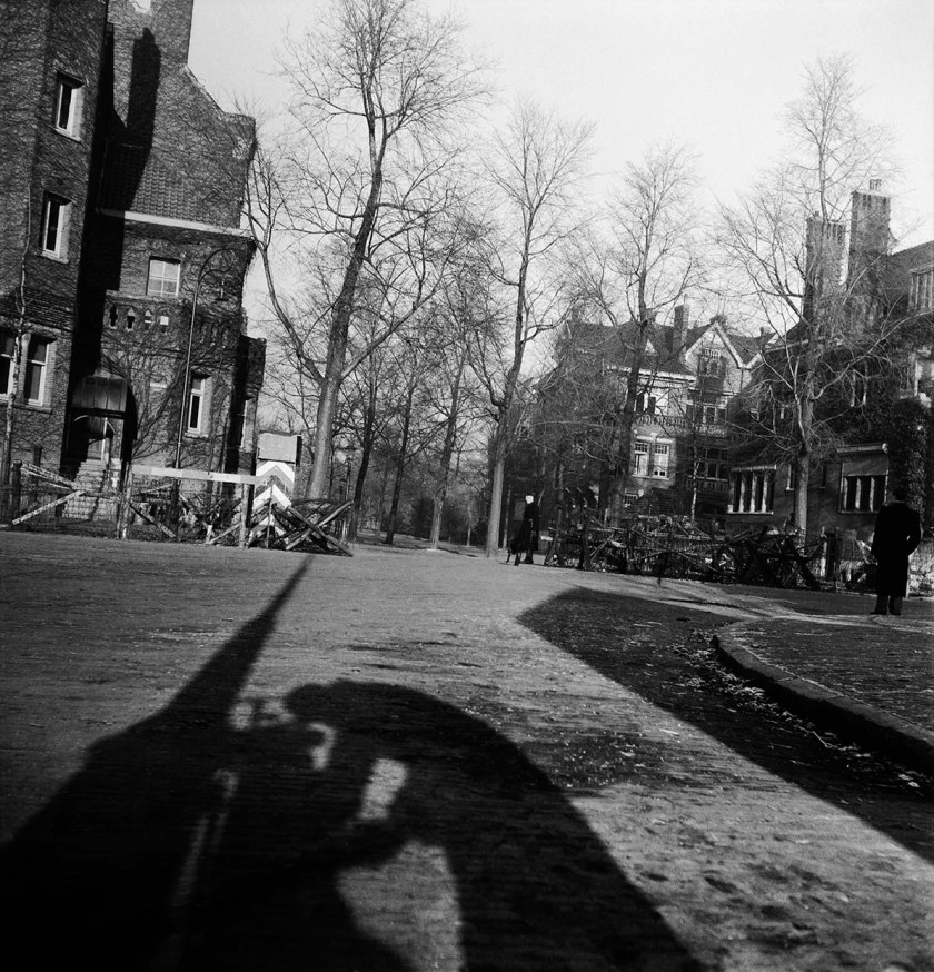 Charles Breijer (Dutch, 1914-2011) 'Charles Breijer photographs a German-requisitioned building near Vondelpark from his bicycle bag. He inadvertently captures his own shadow' Spring 1945