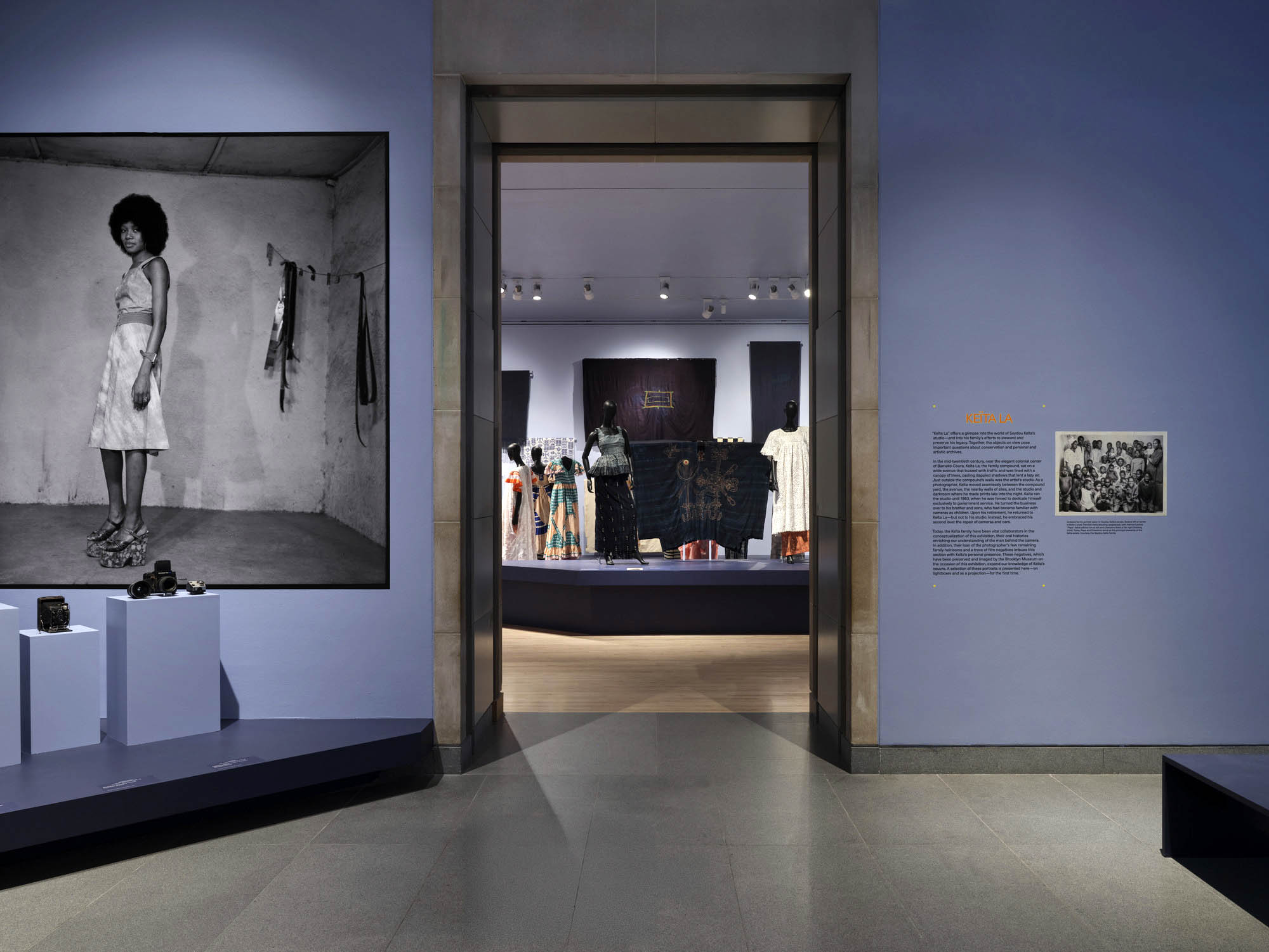 Installation view of the exhibition 'Seydou Keïta: A Tactile Lens' at the Brooklyn Museum, New York, October 2025 - May 2026 showing at left, Keïta's photograph 'Untitled' late 1940s to mid-1970s; and at right, text for the section "Keïta La" together with the photograph 'Undated family portrait taken in Seydou Keïta's studio' Installation view of the exhibition 'Seydou Keïta: A Tactile Lens' at the Brooklyn Museum, New York, October 2025 - May 2026 showing at left, Keïta's photograph 'Untitled' late 1940s to mid-1970s; and at right, text for the section "Keïta La" together with the photograph 'Undated family portrait taken in Seydou Keïta's studio'