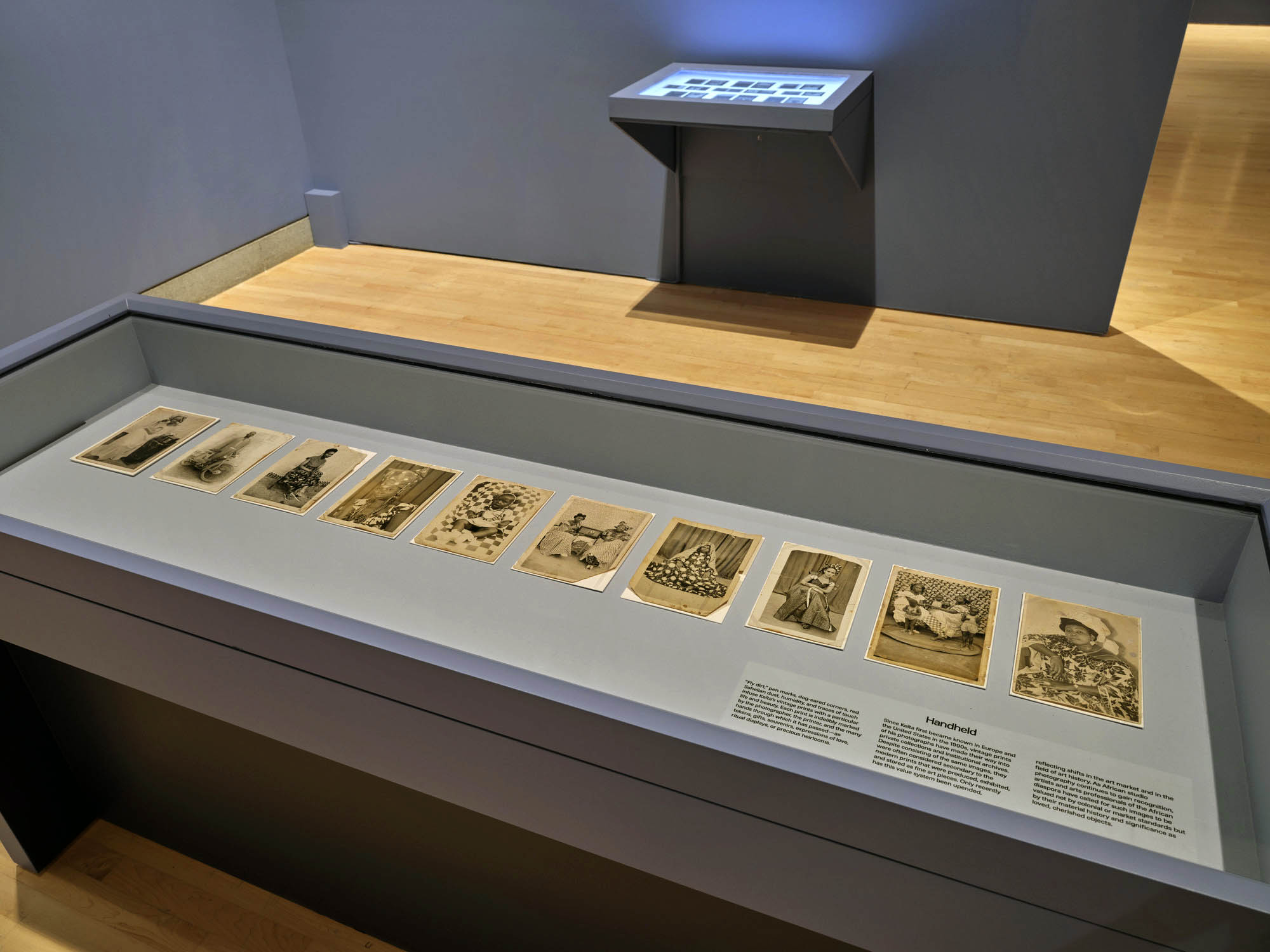 Installation view of the exhibition 'Seydou Keïta: A Tactile Lens' at the Brooklyn Museum, New York, October 2025 - May 2026 showing a vitrine with text from the section "Handheld" Installation view of the exhibition 'Seydou Keïta: A Tactile Lens' at the Brooklyn Museum, New York, October 2025 - May 2026 showing a vitrine with text from the section "Handheld"