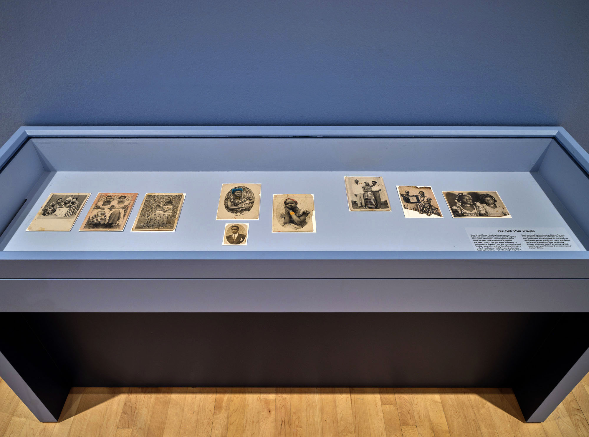 Installation view of the exhibition 'Seydou Keïta: A Tactile Lens' at the Brooklyn Museum, New York, October 2025 - May 2026 showing a vitrine with text from the section "The Self That Travels" Installation view of the exhibition 'Seydou Keïta: A Tactile Lens' at the Brooklyn Museum, New York, October 2025 - May 2026 showing a vitrine with text from the section "The Self That Travels"