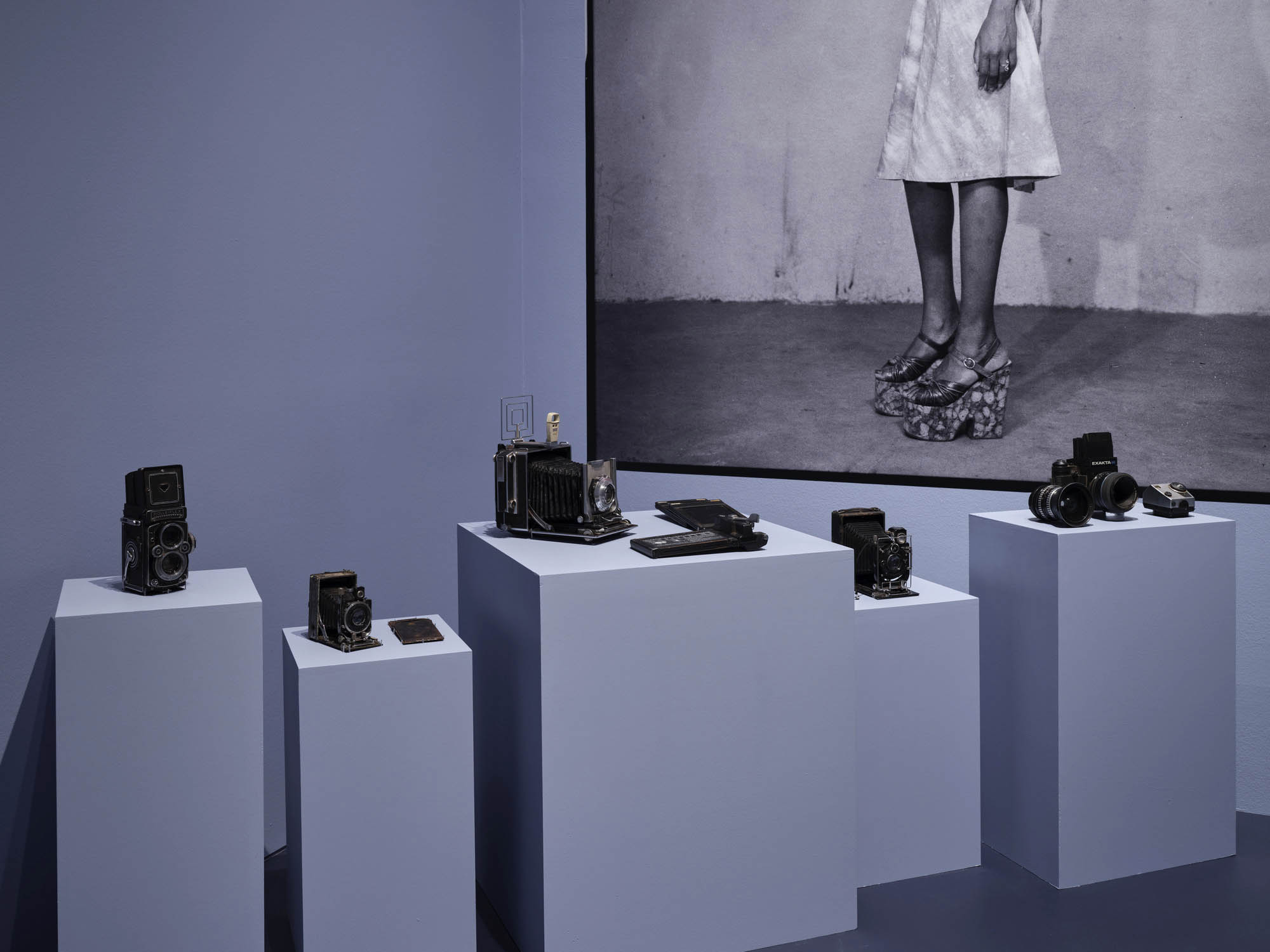 Installation view of the exhibition 'Seydou Keïta: A Tactile Lens' at the Brooklyn Museum, New York, October 2025 - May 2026 showing Keïta's medium format cameras and his photograph, 'Untitled' late 1940s to mid-1970s Installation view of the exhibition 'Seydou Keïta: A Tactile Lens' at the Brooklyn Museum, New York, October 2025 - May 2026 showing Keïta's medium format cameras and his photograph, 'Untitled' late 1940s to mid-1970s
