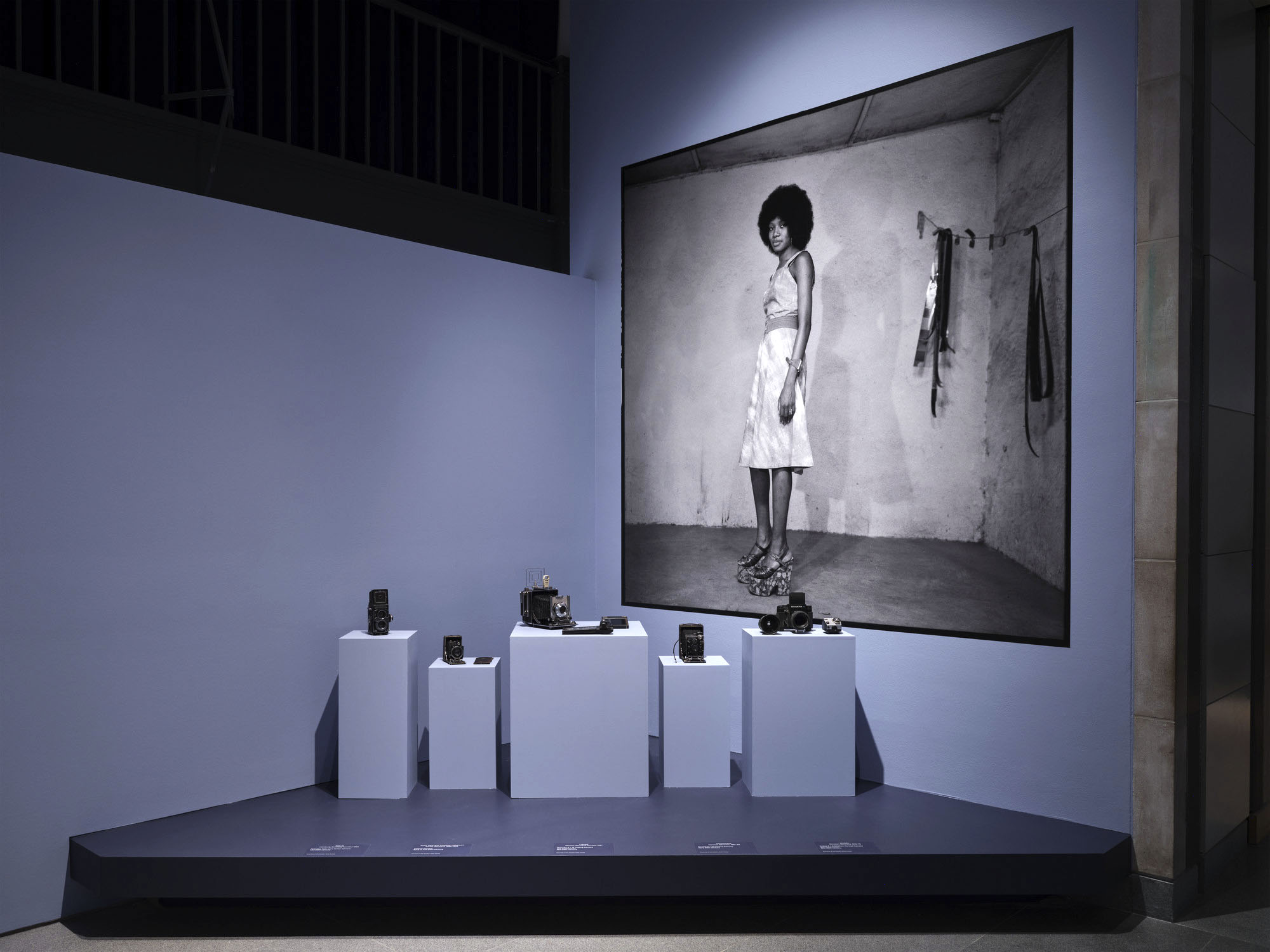 Installation view of the exhibition 'Seydou Keïta: A Tactile Lens' at the Brooklyn Museum, New York, October 2025 - May 2026 showing Keïta's medium format cameras and his photograph, 'Untitled' late 1940s to mid-1970s Installation view of the exhibition 'Seydou Keïta: A Tactile Lens' at the Brooklyn Museum, New York, October 2025 - May 2026 showing Keïta's medium format cameras and his photograph, 'Untitled' late 1940s to mid-1970s