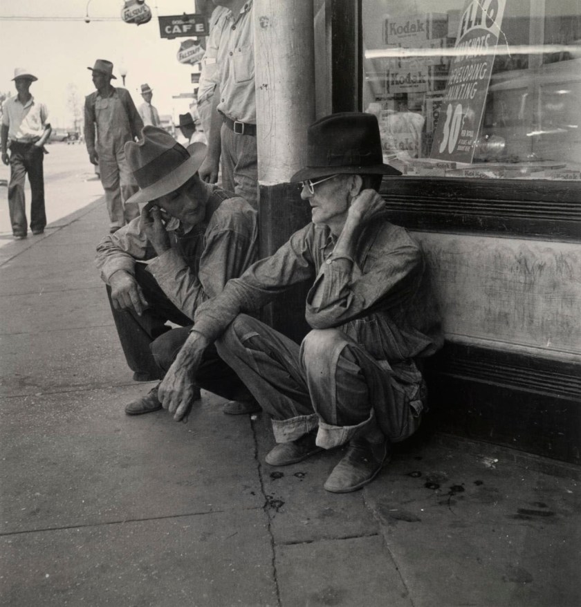Dorothea Lange (American, 1895-1965) 'Drought-stricken farmers on the shady side of town street while their crops burn up in the fields, Sallisaw, Oklahoma' 1936, printed c. 1975