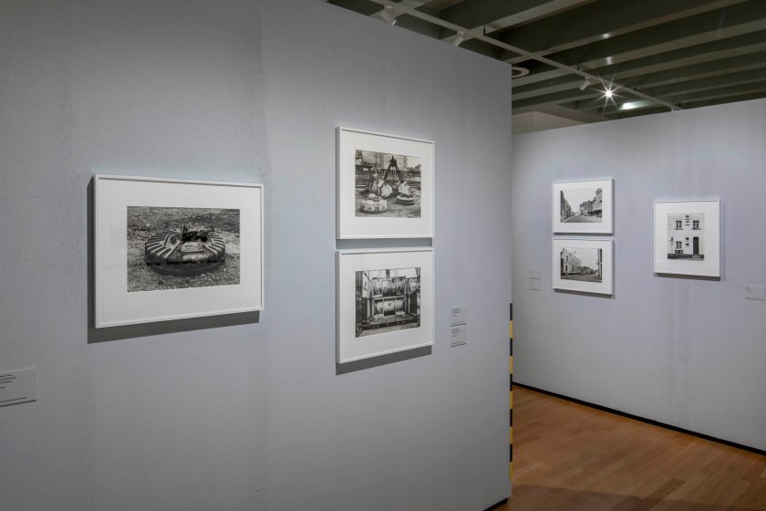 Installation view of the exhibition Designed World: Through the Eyes of Tata Ronkholz (1940-1997) at Huis Marseille, Amsterdam, February - June, 2026 showing at left, Tata Ronkholz's 'Düsseldorf Harbor' (1980)