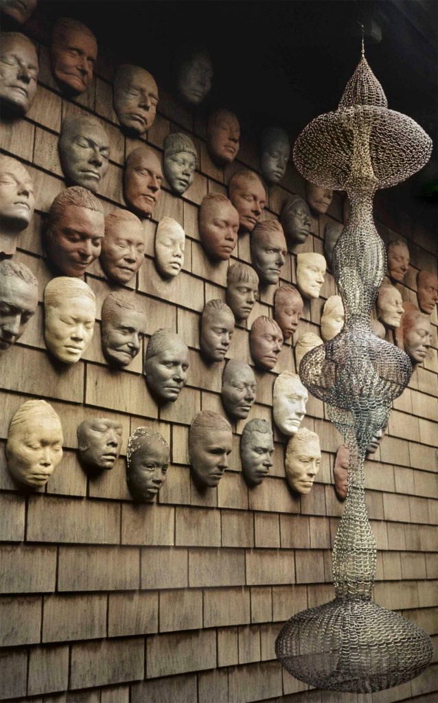 Laurence Cuneo (American) 'Ruth Asawa's Untitled (S.540, Hanging Seven-Lobed, Interlocking Continuous Form within a Form) hanging in front of the artist's Wall of Masks (LC.012) on the exterior of her home in San Francisco' c. 1973 Laurence Cuneo (American) 'Ruth Asawa's Untitled (S.540, Hanging Seven-Lobed, Interlocking Continuous Form within a Form) hanging in front of the artist's Wall of Masks (LC.012) on the exterior of her home in San Francisco' c. 1973