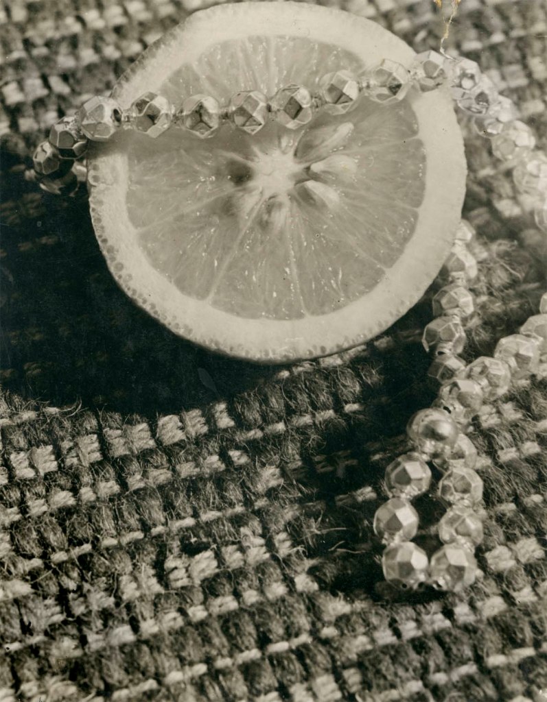 Lony Neumann (German, 1902-1996) 'Stillleben mit Zitrone und Perlenkette auf Webteppich' (Still life with lemon and pearl necklace on a woven carpet) 1930