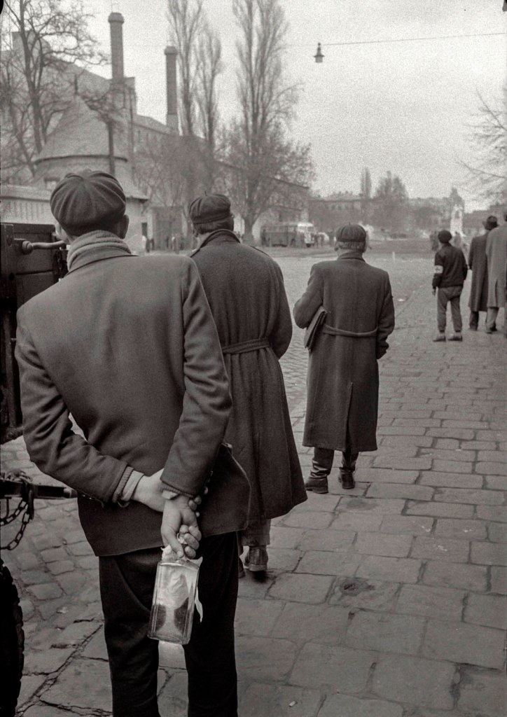 John Sadovy (English born Czech, 1925-2010) 'Three men watching the events around an ambulance bus' Hungary October 1956