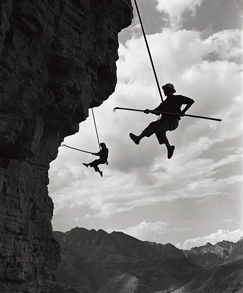 Wei Dezhong (Chinese, b. 1934) 'At the Red Flag Canal construction project, suspended labourers cut a channel' 1960
